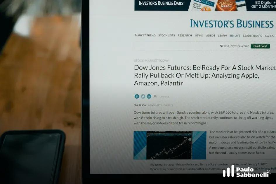 Monitor exibe site de notícias financeiras com artigo sobre futuros do índice Dow Jones