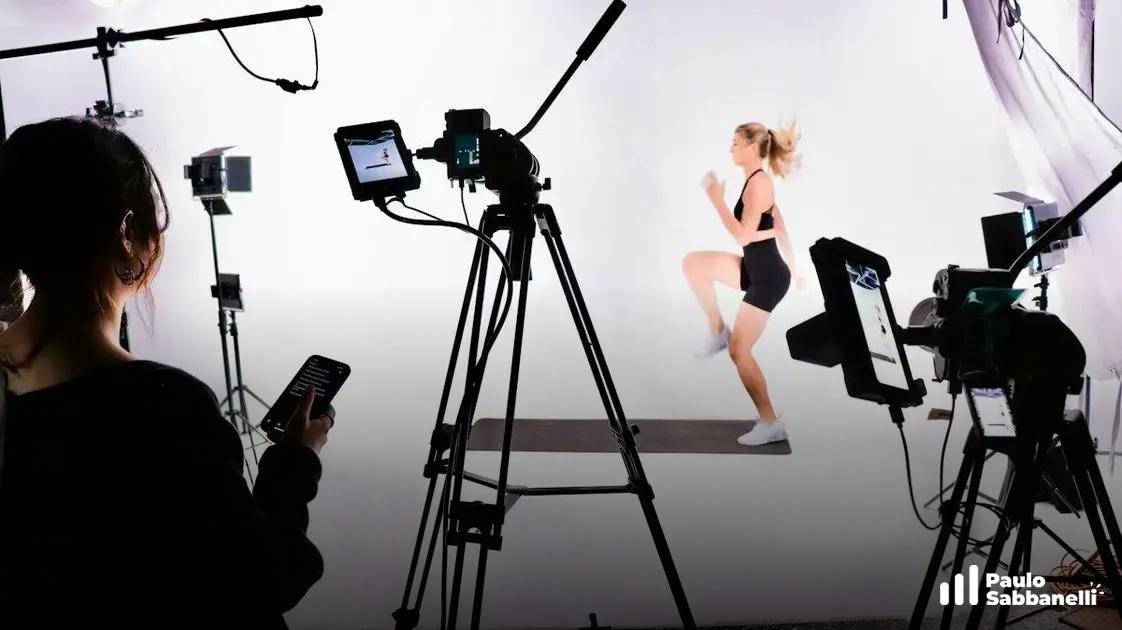 Equipe de filmagem grava mulher se exercitando em estúdio cercado por câmeras, luzes e tripés